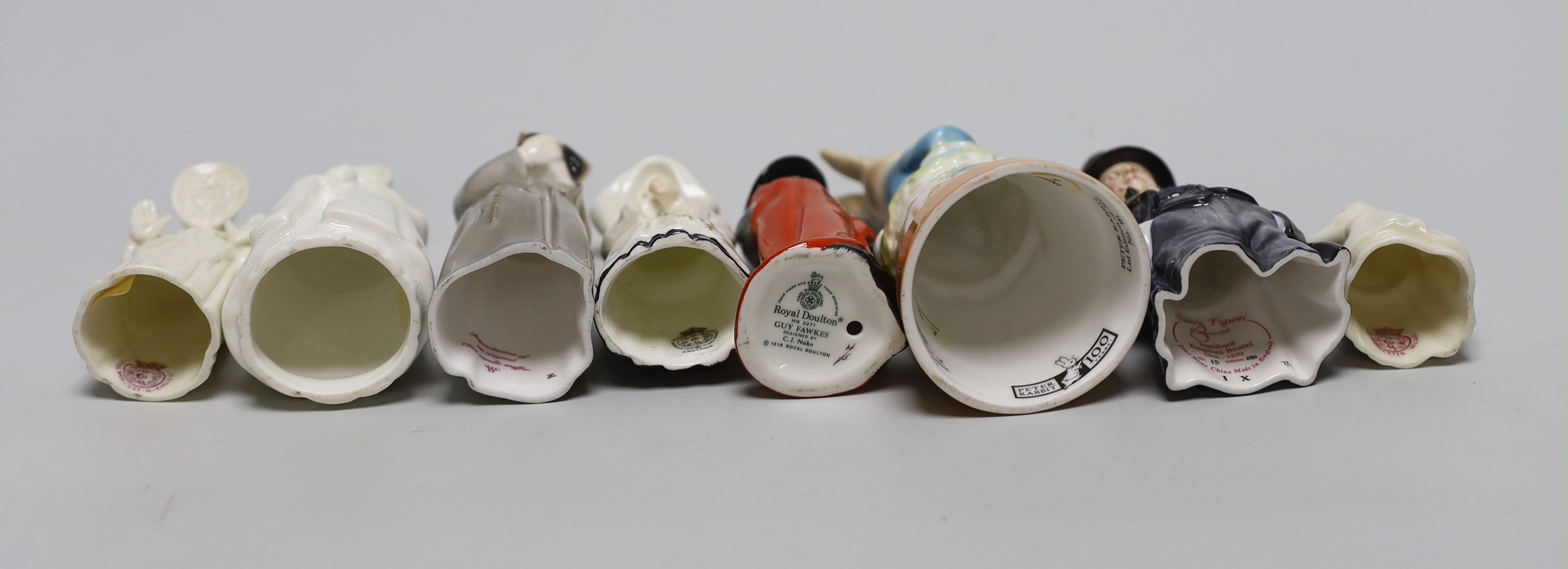 A collection of eight extinguishers including Worcester and Royal Doulton, the largest 13cm high